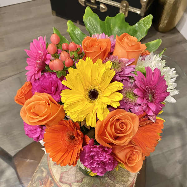 Bright mixed bouquet with orange roses, gerbera daisies, and pink flowers