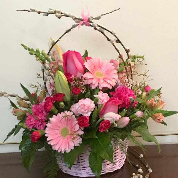 Pink mixed flower basket with arching pussy willow branches