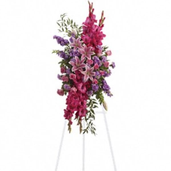 Tall standing floral spray with pink and purple flowers on an easel