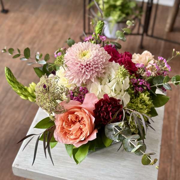 Mixed bouquet with pink and peach roses, a pale pink chrysanthemum, and white hydrangea