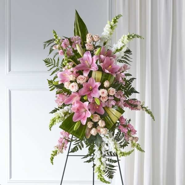 Tall standing floral spray with pink lilies, roses, and white snapdragons