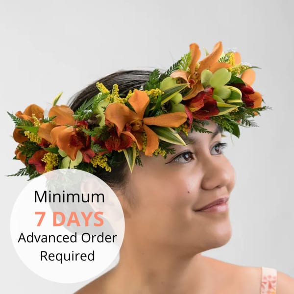 Floral crown of orange, red, and green flowers worn on a woman's head