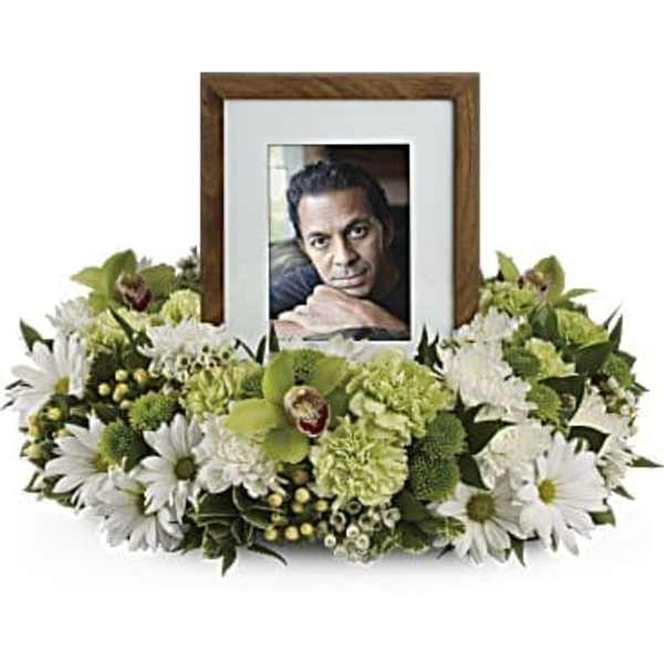 White floral frame around a photo in a wooden frame