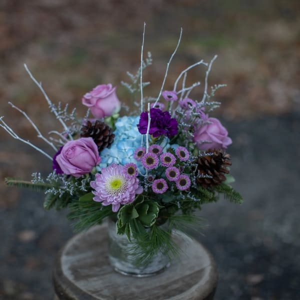 Lavender and purple bouquet in a clear glass vase