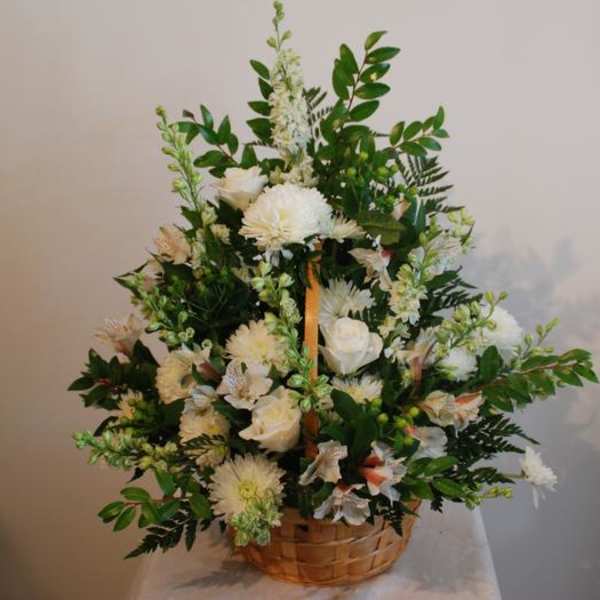 White floral arrangement in a woven basket