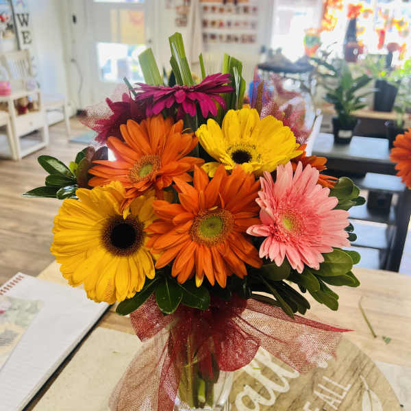 Bouquet of colorful gerbera daisies in a glass vase