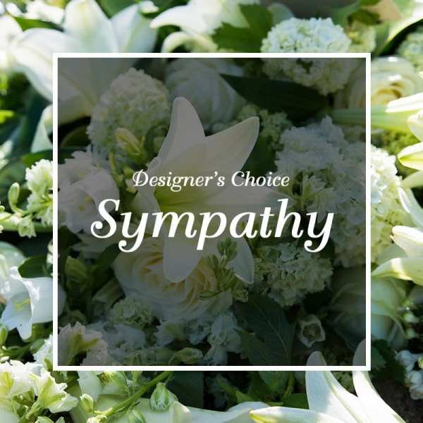 White lilies and roses arranged closely together for a sympathy floral design