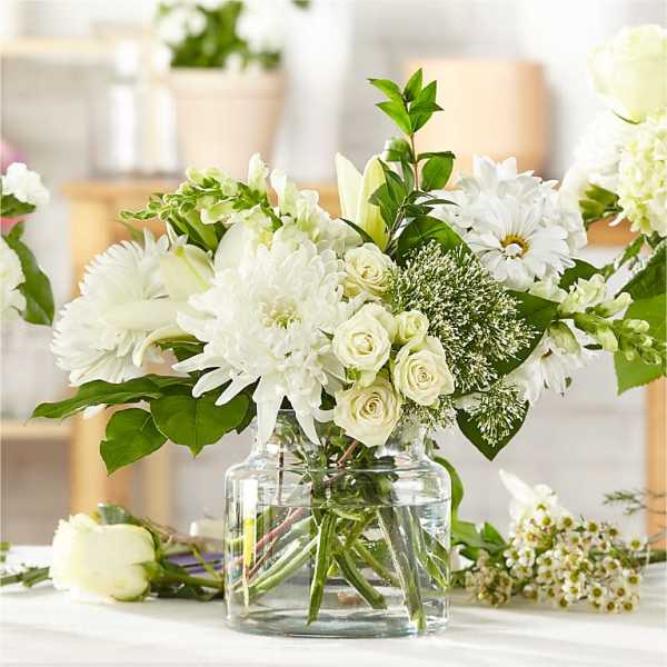 White floral arrangement in a clear glass vase
