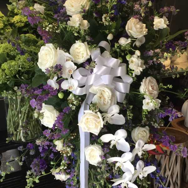 Large standing floral spray with white roses and purple flowers