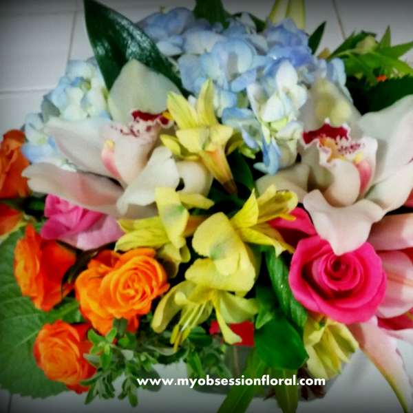 Mixed bouquet with roses, lilies, hydrangeas, and orchids