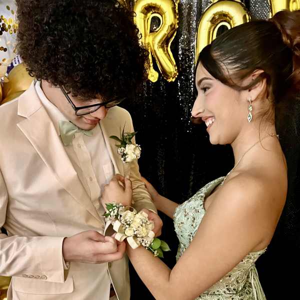 Young couple at a formal event with a boutonniere and corsage