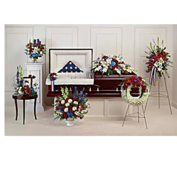 Funeral casket spray and wreaths in red, white, and blue