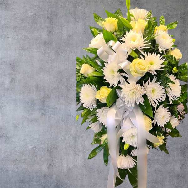 White and pale yellow floral standing spray with ribbon