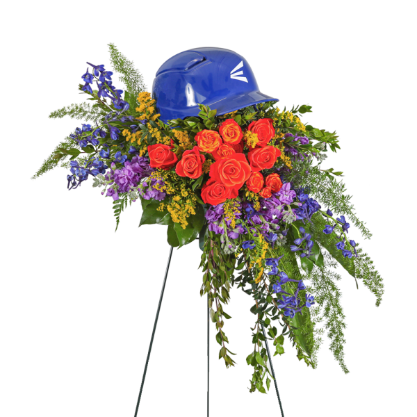 Floral tribute with red roses and purple flowers topped by a blue hard hat