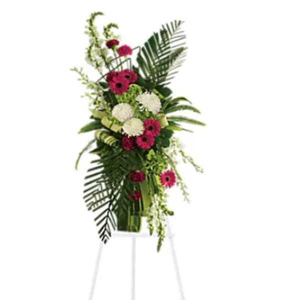 Tall standing floral spray with pink and white blooms on an easel