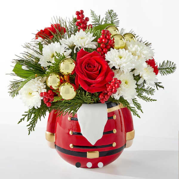 Christmas bouquet in a Santa-shaped vase with red and white flowers