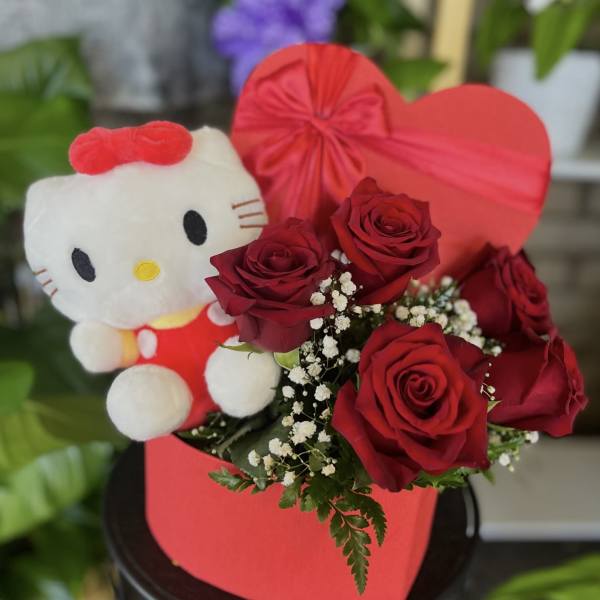 Red roses with a Hello Kitty plush in a heart-shaped box