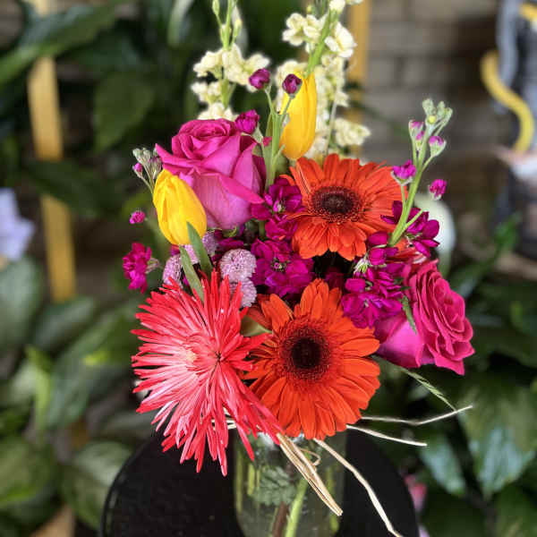 Bright mixed bouquet with pink roses, orange gerberas, and yellow tulips