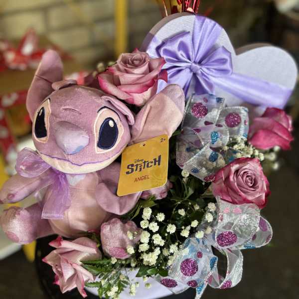 Pink rose bouquet with a Stitch plush and lavender ribbon