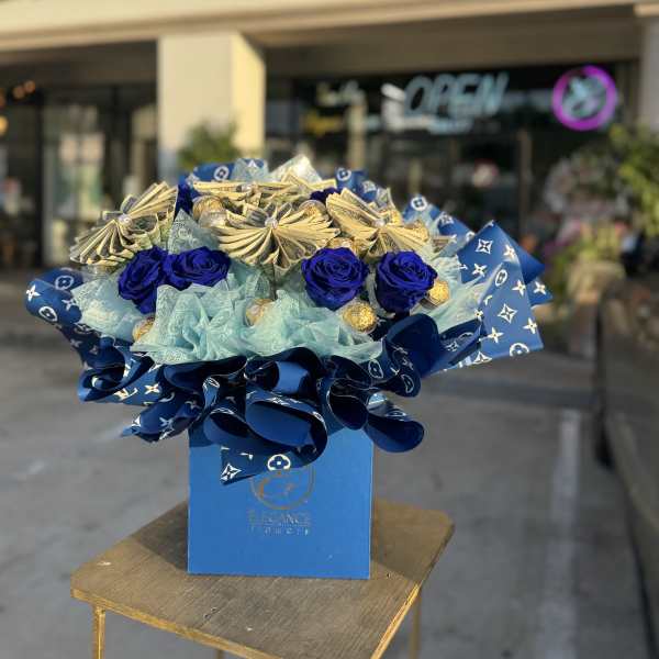 Blue roses and gold money-fold accents in a blue gift box