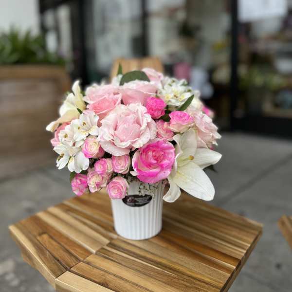 Pink and white flower arrangement in a white vase