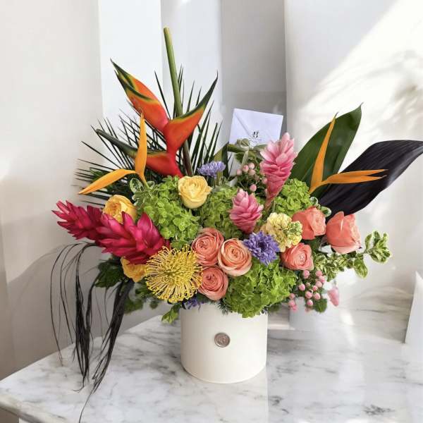 Tropical bouquet in a white hatbox with pink and orange flowers