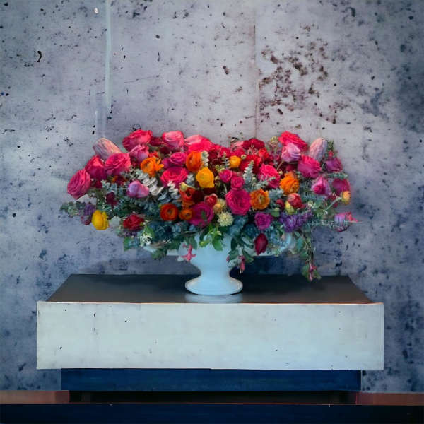 Large mixed bouquet in a white pedestal vase