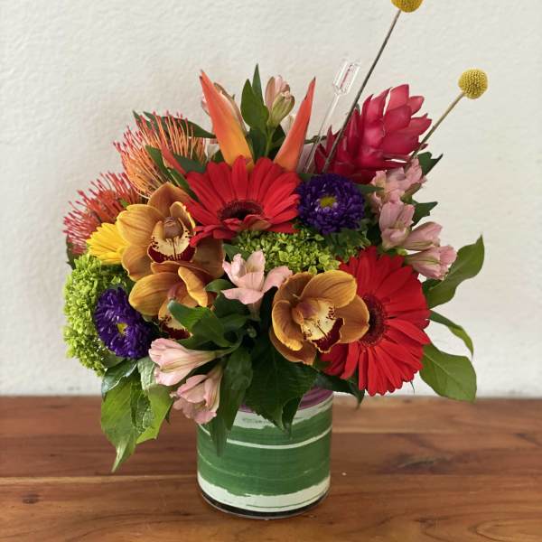 Colorful mixed bouquet in a green-striped glass vase
