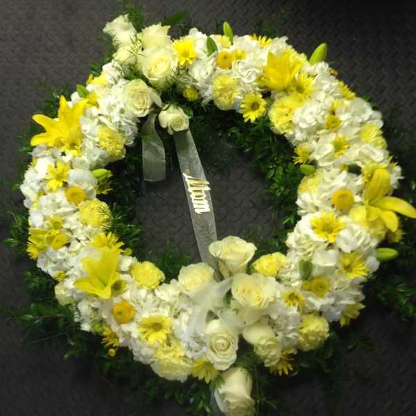 Yellow and white floral wreath with roses and lilies