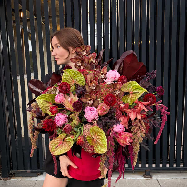 Large bouquet in a red hatbox with pink and burgundy flowers