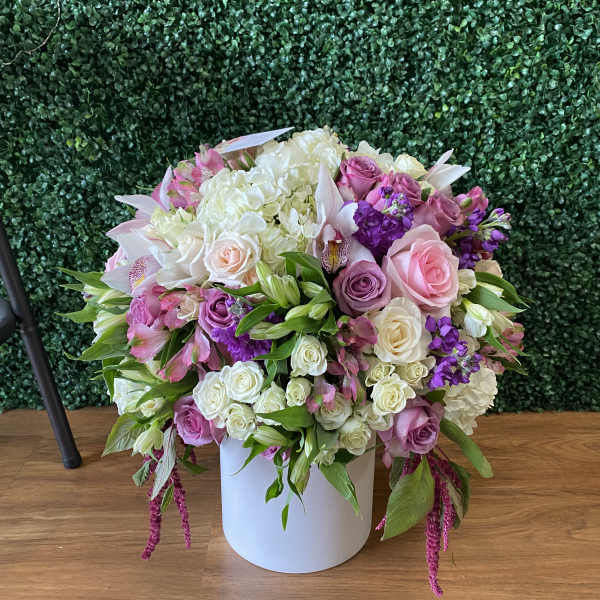 Large pastel flower arrangement in a white vase