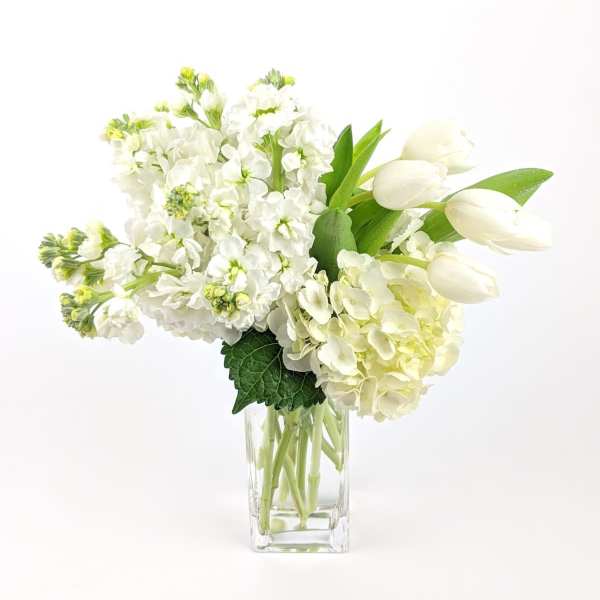 White flowers arranged in a clear glass vase