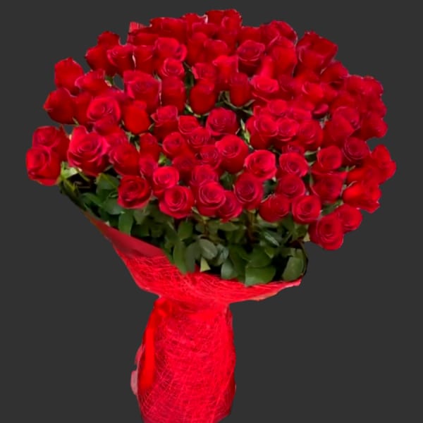 Large bouquet of red roses wrapped in red paper
