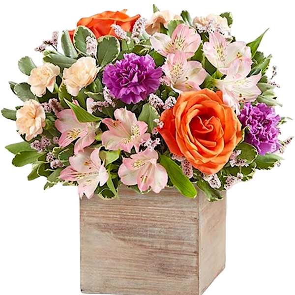 Mixed bouquet in a wooden box with orange and pink flowers