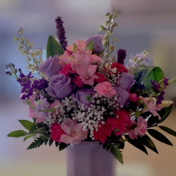 Pink and purple mixed bouquet in a lavender vase