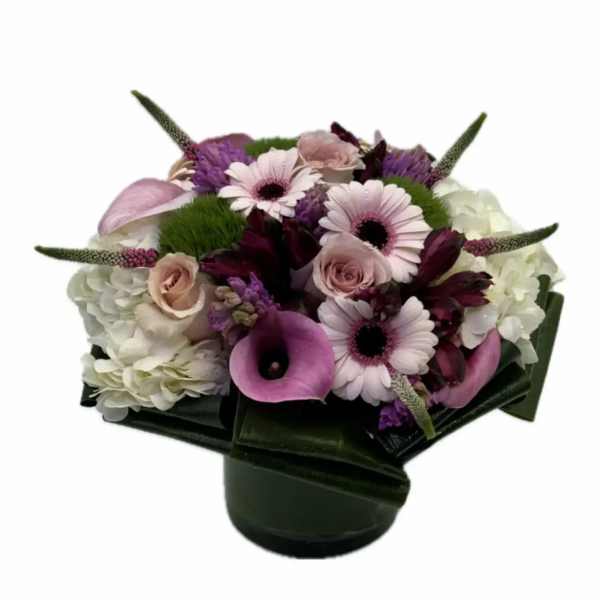 Bouquet of pink and white flowers in a dark vase