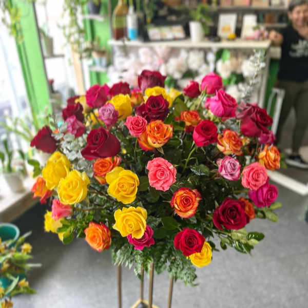 Large bouquet of multicolored roses on a tall stand