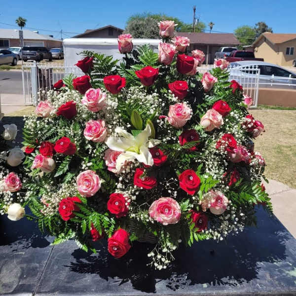 Large rose arrangement with white lilies and baby's breath