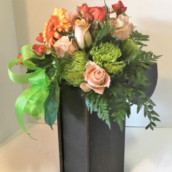 Bouquet of roses, gerbera daisy, and green chrysanthemums in a black vase
