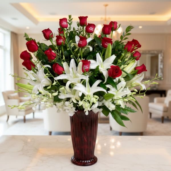 Red roses and white lilies arranged in a tall vase
