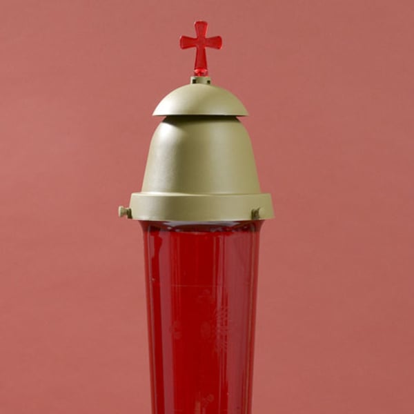 Red glass memorial candle lantern with a cross topper