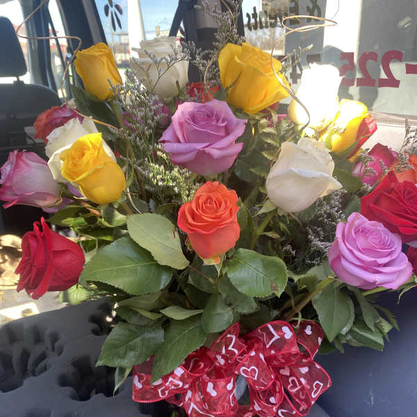 Bouquet of multicolored roses with a red heart ribbon
