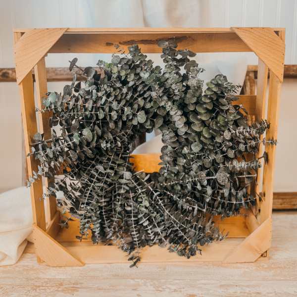 Wooden crate filled with dried eucalyptus branches
