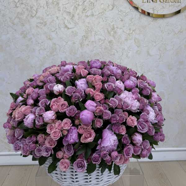 Large basket of pink and lavender roses and peonies