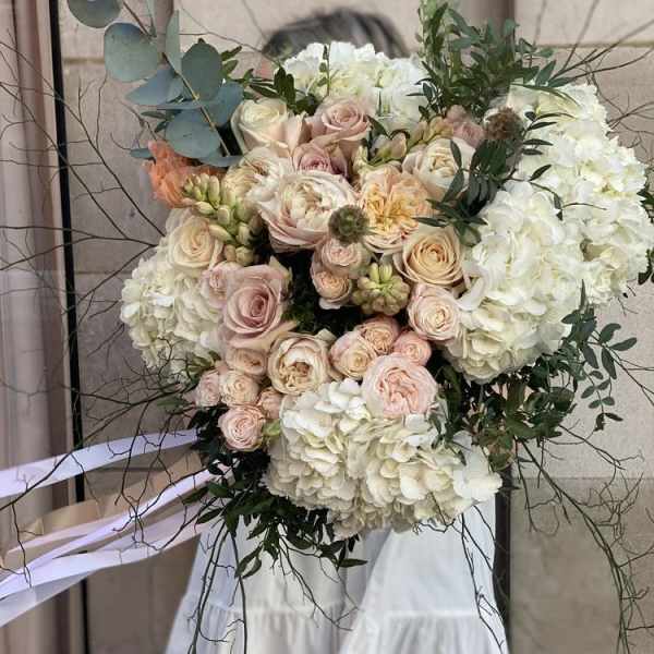 Large bouquet of blush roses and white hydrangeas with eucalyptus