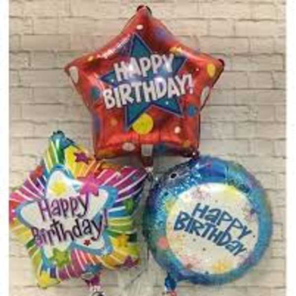 Three colorful birthday balloons on sticks in a small base