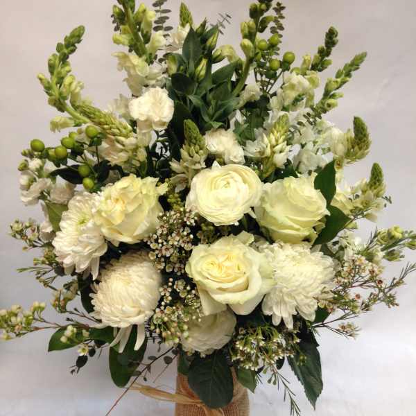 White floral bouquet in a burlap-wrapped vase