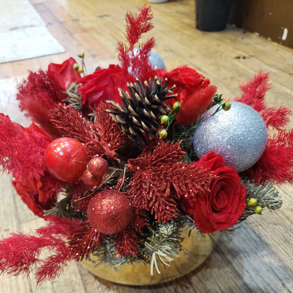 Red roses with glittery ornaments in a gold container
