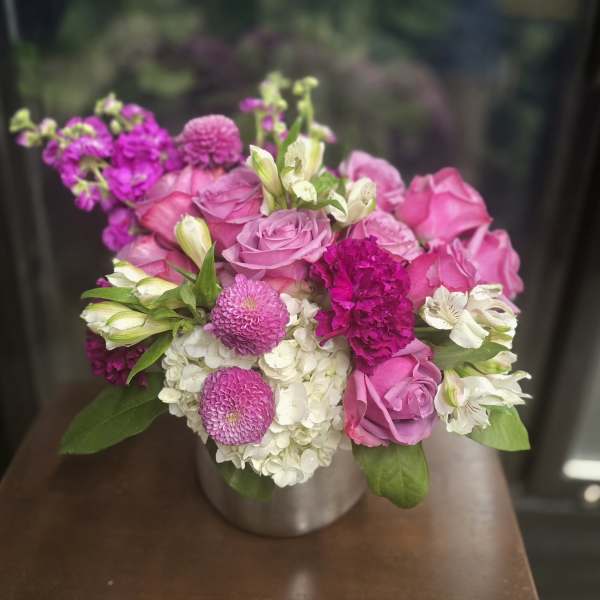 Pink roses and white hydrangeas in a silver vase