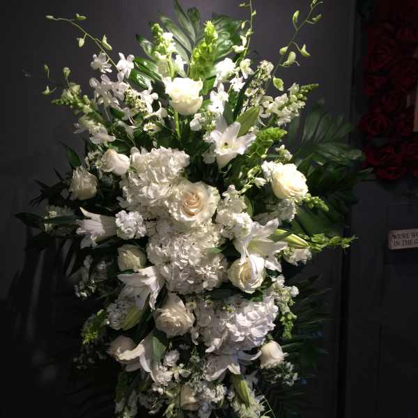 Tall white floral standing spray with roses, lilies, and hydrangeas